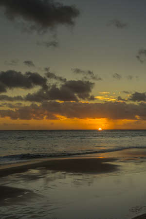 Sunset on the Atlantic coast with dark clouds and little wavesの写真素材