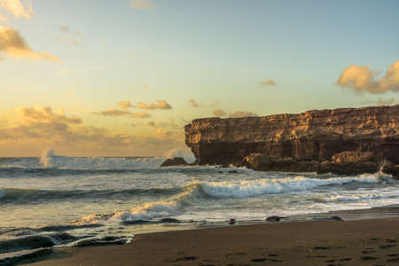 Sunshine on the Atlantic Ocean with big rocks and big wavesの写真素材