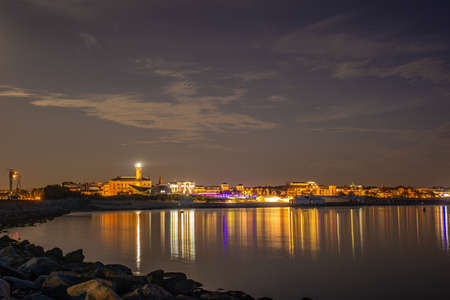 The skyline of WarnemÃ¼nde a city by the sea at nightの写真素材