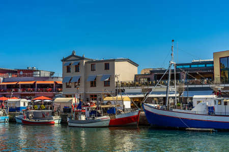 A small harbor during the day with many small boatsの写真素材