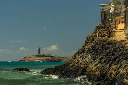 Wild and rough volcanic coast overlooking the lighthouse of Punta Jandia, Fuerteventura, Canary Islandsの写真素材
