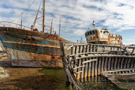 rotting ships with peeling paint and rotten structures on the Cemetery boat in Brittany, Franceの写真素材
