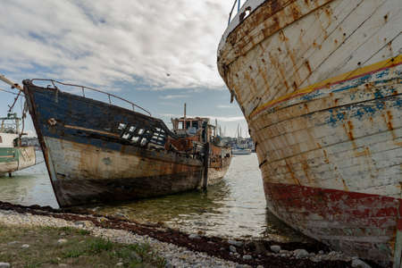 rotting ships with peeling paint and rotten structures on the Cemetery boat in Brittany, Franceの写真素材