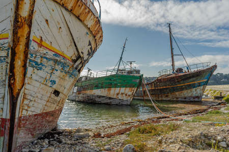 rotting ships with peeling paint and rotten structures on the Cemetery boat in Brittany, Franceの写真素材
