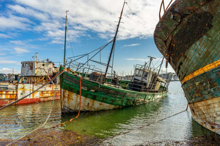 rotting ships with peeling paint and rotten structures on the Cemetery boat in Brittany, Franceの写真素材