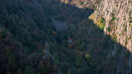 View from a high mountain in a valley with houses and treesの写真素材