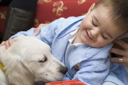 A little child playing with his pet.の写真素材