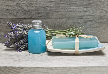 Lavender and some hygiene items made of lavender on an old wooden shelf.の写真素材