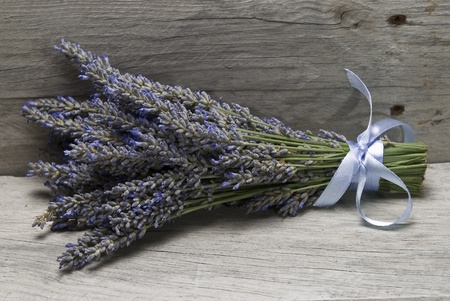 A bouquet of lavender on a wooden shelf.の写真素材