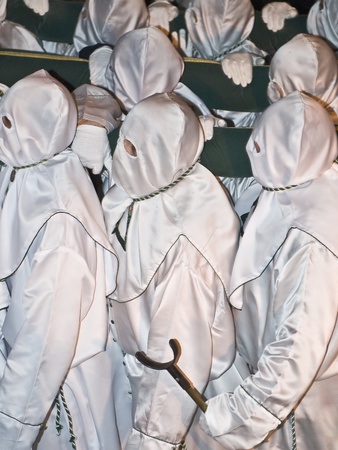 Easter nazarenes in white robe in a typical Spanish procession  の写真素材