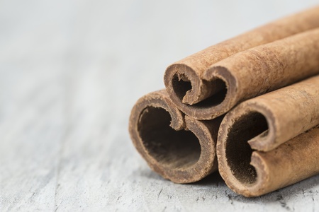 Cinnamon sticks on an old wooden table backgroundの写真素材