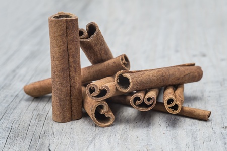 Cinnamon sticks on an old wooden table backgroundの写真素材