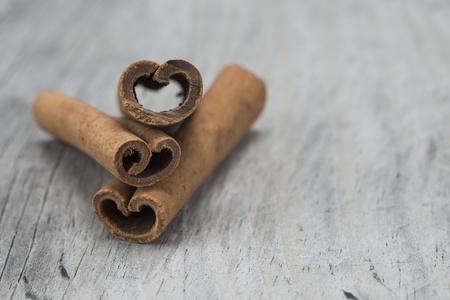 Cinnamon sticks on an old wooden table backgroundの写真素材