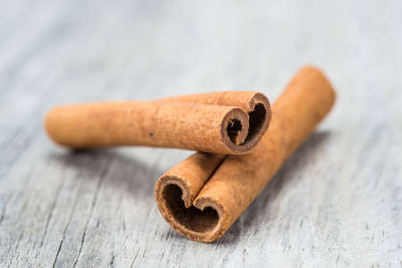 Cinnamon sticks on an old wooden table backgroundの写真素材