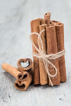 Cinnamon sticks on an old wooden table background