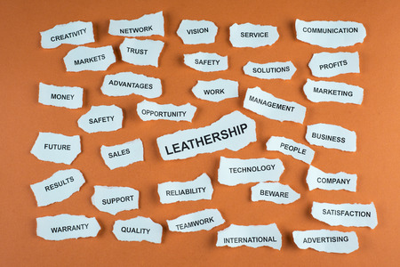 Concepts about business written on scraps of paper with an orange background