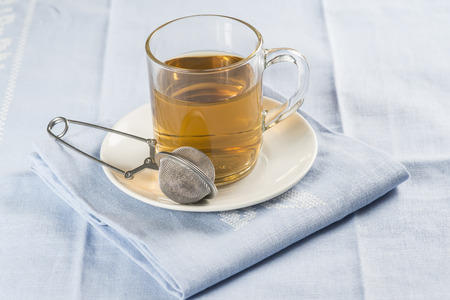 Mentha pulegium infusion with the infuser on the saucerの写真素材