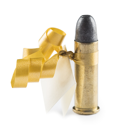Bullet with a greeting card decorated like a gift and meaning threat isolated on a white background