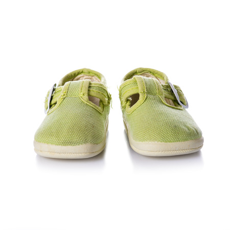 Green sneakers shoes with buckles for kids isolated on a white backgroundの写真素材