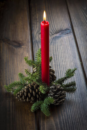 Christmas greeting card with candles over a wooden background and a magical atmosphereの写真素材