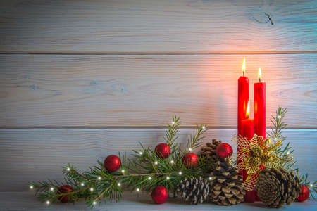 Christmas wooden background with candles and a space for textの写真素材