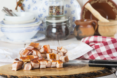 Raw diced bacon on the kitchen table ready to cookの写真素材