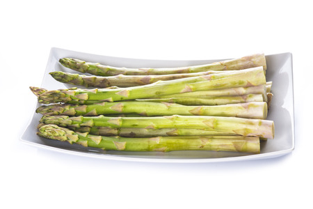 Asparagus on a tray isolated on a white backgroundの写真素材