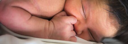 Mother breastfeeding her newborn baby in her first daysの写真素材