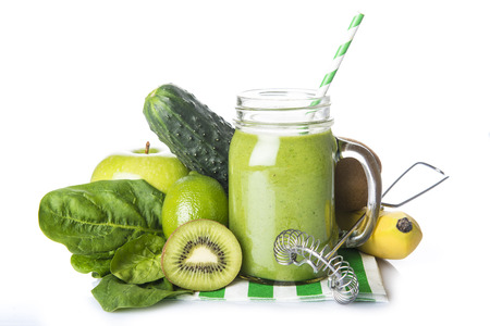 Fresh homemade green smoothie and ingredients isolated on a white backgroundの写真素材