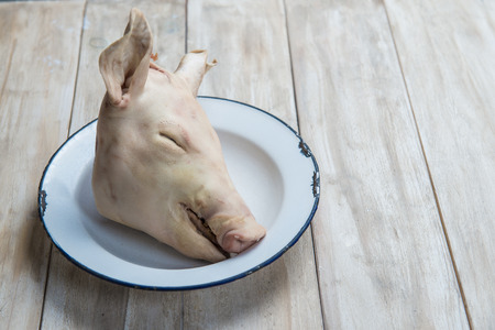 Raw head of a sucking pig ready to be cookedの写真素材
