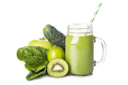 Fresh homemade green smoothie and ingredients isolated on a white backgroundの写真素材