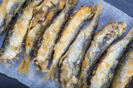 Fried sardines or pirchards on a slate backgroundの写真素材