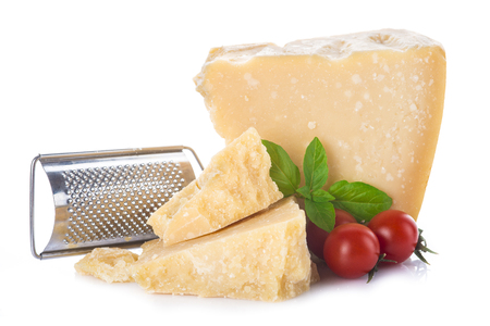 Parmesan cheese or parmigiano reggiano with cherry tomatoes and basil leaves isolated on a white backgroundの写真素材