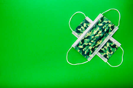 Camo surgical face mask as protection to covid 19 coronavirus pandemicの写真素材