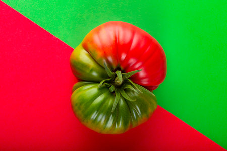 Tomato red and green on a background with the same colorsの写真素材