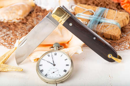 Vintage still life about fishing with a pipe and a sailor knife