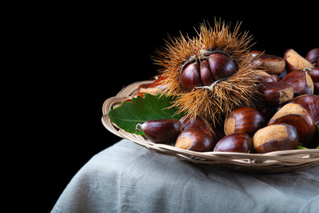 Chestnut with leaves on a wooden backgroundの写真素材