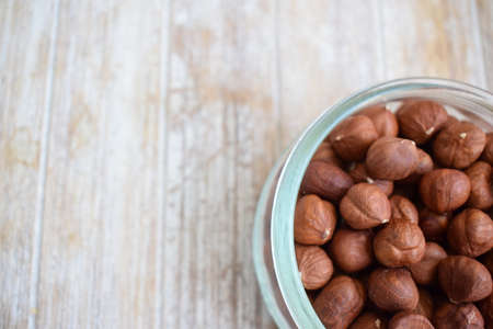 tree nuts in a glass jar isolated on white backgroundの写真素材