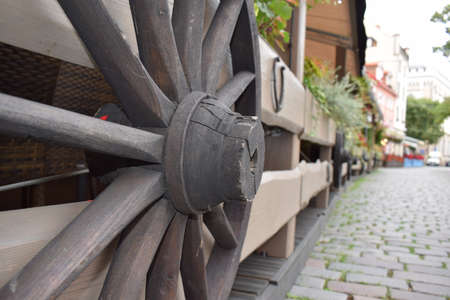 wooden wheel of carts on the fence.