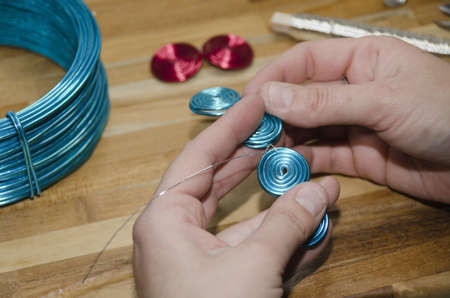 woman's hand creating a fashion bracelet