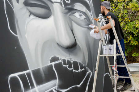 Vers Gard, France- october 16, 2016 a showing of a young graffiti artist during drawing and painting his artworkのeditorial素材