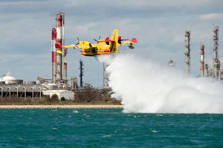 Marseille, France - March 30, 2015: Canadair water bomber plane in training in the harbor near a...