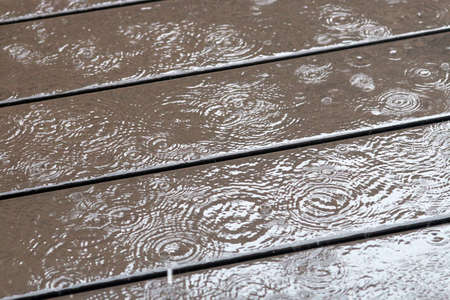 Raining on the wooden boarded floor.