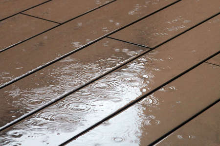 Raining on the wooden boarded floor.の写真素材
