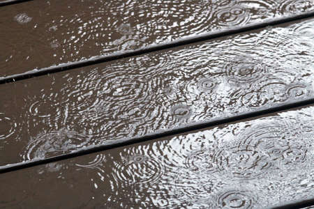 Waves of the Raining on the wooden boarded floor.の写真素材