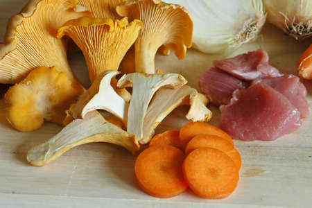 Still life about cooking. Turkey and chanterelles stew ingredients.の写真素材