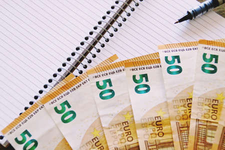 Banknotes of 50 euros and a notebook.の写真素材