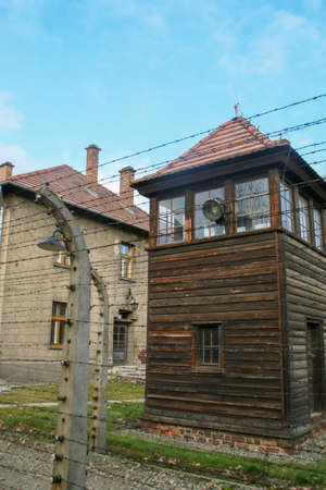 Auschwitz I concentration camp (in Oswiecim). Checkpoint, electrified fence and barracks of the...