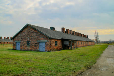 Auschwitz-Birkenau concentration camp. Barracks of the concentration camp prisoners next to an old horse carriage.のeditorial素材