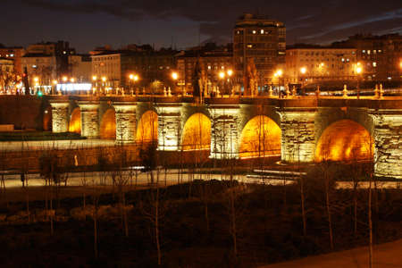 Toledo Bridge illuminated in Madrid at night (Spain).の写真素材